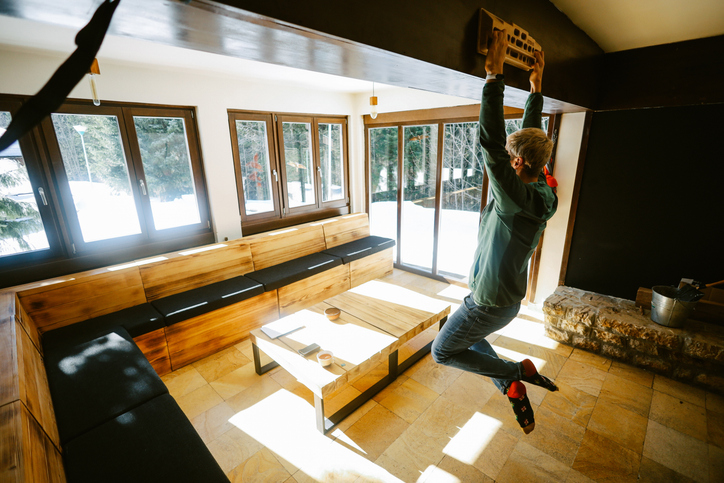 Young man doing a morning routine free climbing exercise, practicing with a hang board.